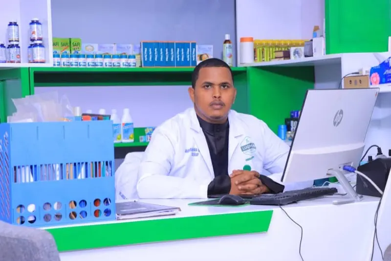 Abdirahman Sadiq Yusuf at the clinic reception desk